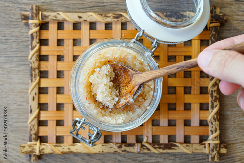 Homemade DIY skin scrub with epsom salt, honey and essential oils. photo