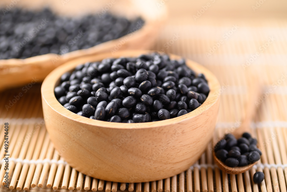 Black soybean seeds in wooden bowl, Food ingredients Black soybean seeds in wooden bowl, Food ingredients