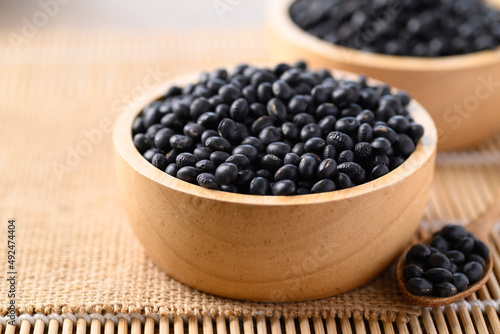 Black soybean seeds in wooden bowl, Food ingredients