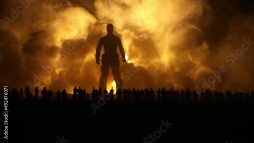 Creative artwork decoration - Russian war in Ukraine concept. Crowd looking on giant explosion and silhouette of giant person. Selective focus