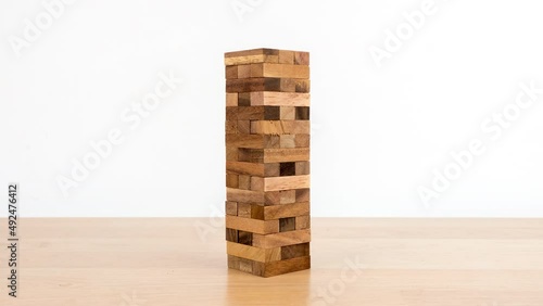 Stop motion animation Game with wooden blocks on white background, Wooden blocks stacked, Planning, risk and strategy in business.