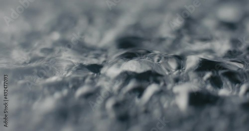 Hot boiling water surface drops waves evaporate in macro close up