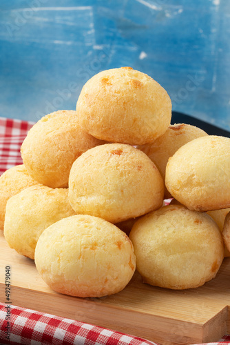 Pile of cheese bread on cutting board.