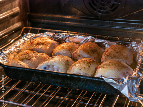 Chicken thighs cooking in the oven