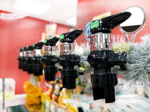 Draught beer, a view of the tap from the bottom. Decoration with yellow tinsel. Beer taps in a shop or pub. Without a man. Selective focus. The concept of alcohol. photo