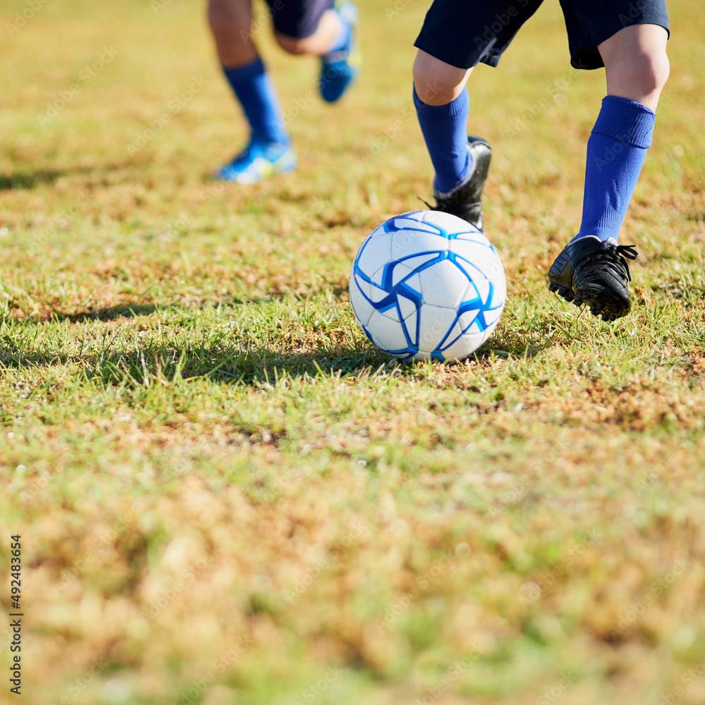 Charging the goal. Shot of two unidentifiable children playing soccer outside on a sunny day. Charging the goal. Shot of two unidentifiable children playing soccer outside on a sunny day.