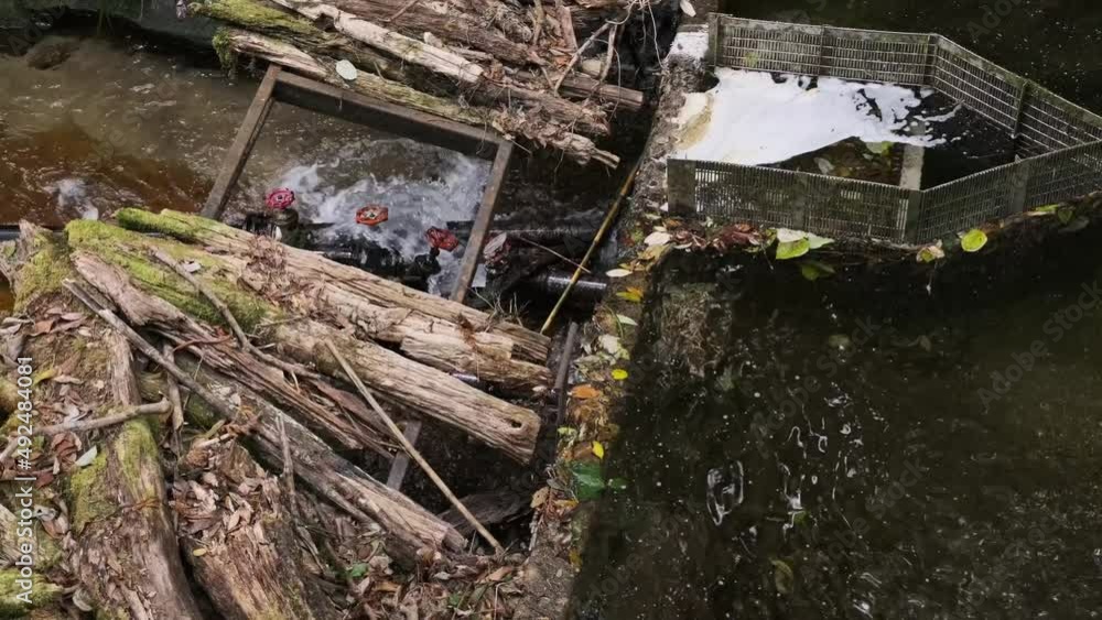 The structure opened a floodgate on a weir in a damaged river. The structure opened a floodgate on a weir in a damaged river.
