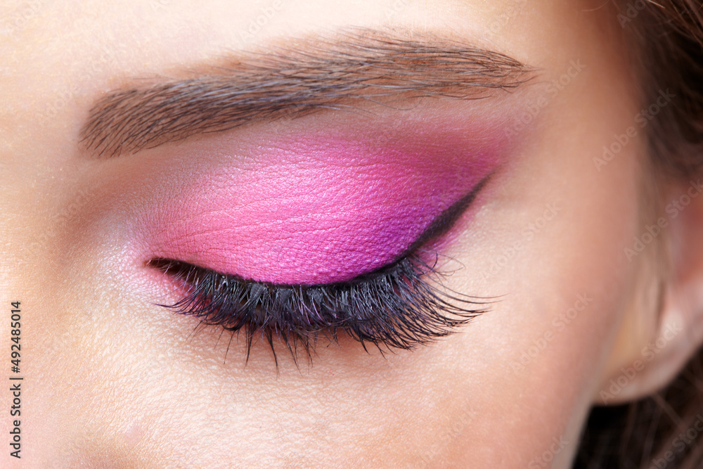 Obraz premium Closeup macro shot of closed human female eye. Girl with perfect skin and pink eyes shadows