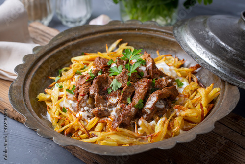 Turkish food; Cokertme Kebab - Beef meat kebab with yoghurt and french fries