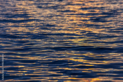 sea wave close up, low angle view. reflection of sun lights