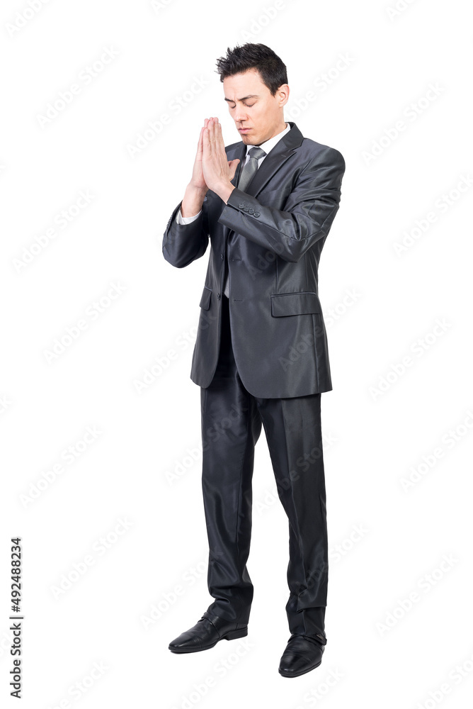 Serene man in suit praying with closed eyes Serene man in suit praying with closed eyes