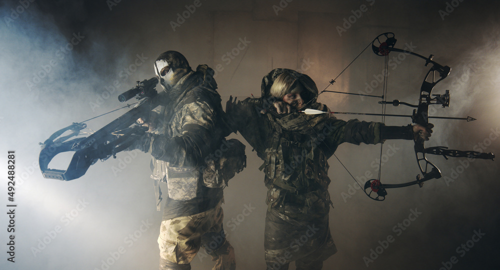Naklejka premium apocalypse fighters. a girl with a bow and a guy with a crossbow.