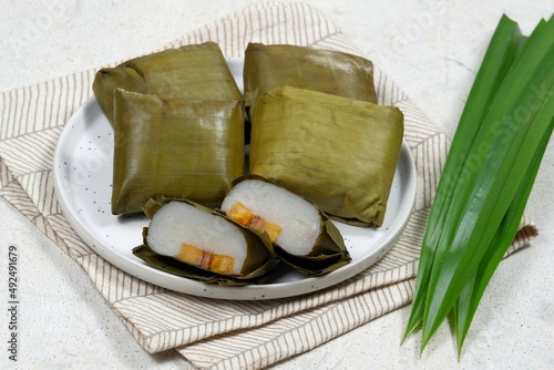 Nagasari or nogosari (in Javanese) is one of Indonesia's famous traditional cakes, made from rice flour, coconut milk, and sugar filled with banana slices.  wrapped in banana leaves, then steamed. photo