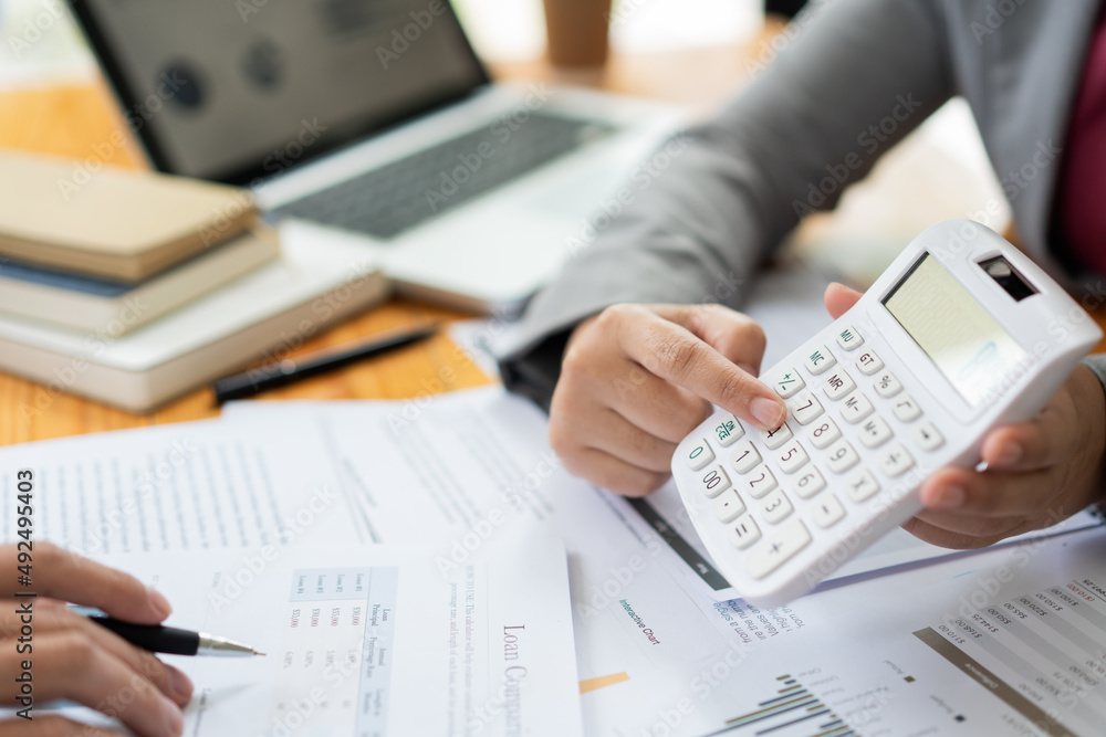 Business negotiation concept the female broker estimating the number of estate and checking it with the male broker Business negotiation concept the female broker estimating the number of estate and checking it with the male broker
