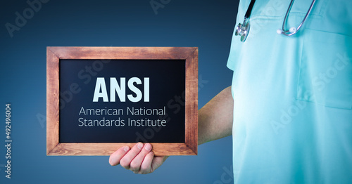 ANSI (American National Standards Institute). Doctor shows sign/board with wooden frame. Background blue photo