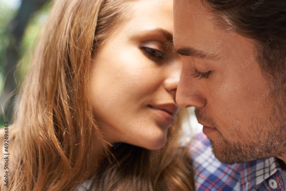 Feeling the romance. Closeup shot of a young couple sharing a tender moment while enjoying a day outside.