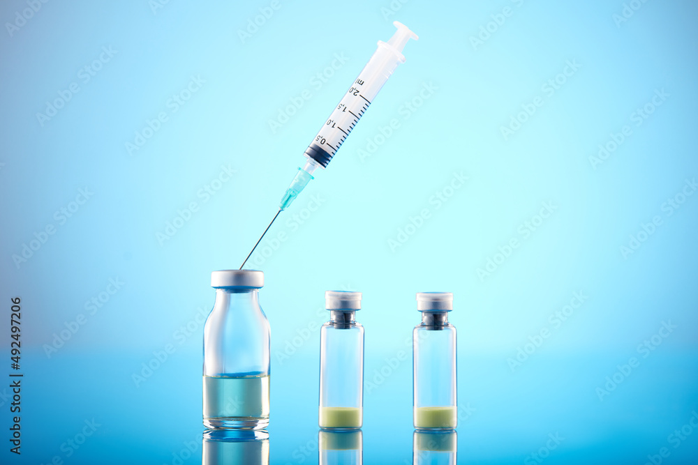 Vaccine vial dose flu shot drug needle syringe. Vaccine vial dose flu shot drug needle syringe.