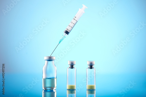Vaccine vial dose flu shot drug needle syringe.