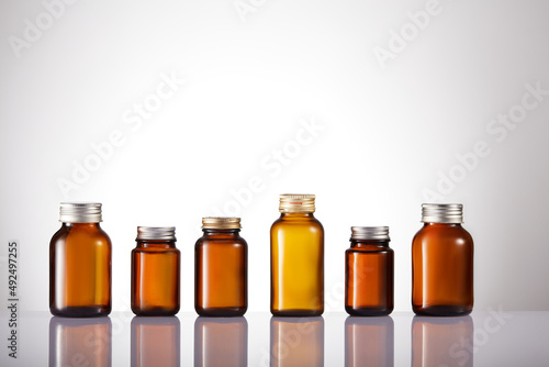 Set of empty brown glass medicine bottles. Amber bottle samples.