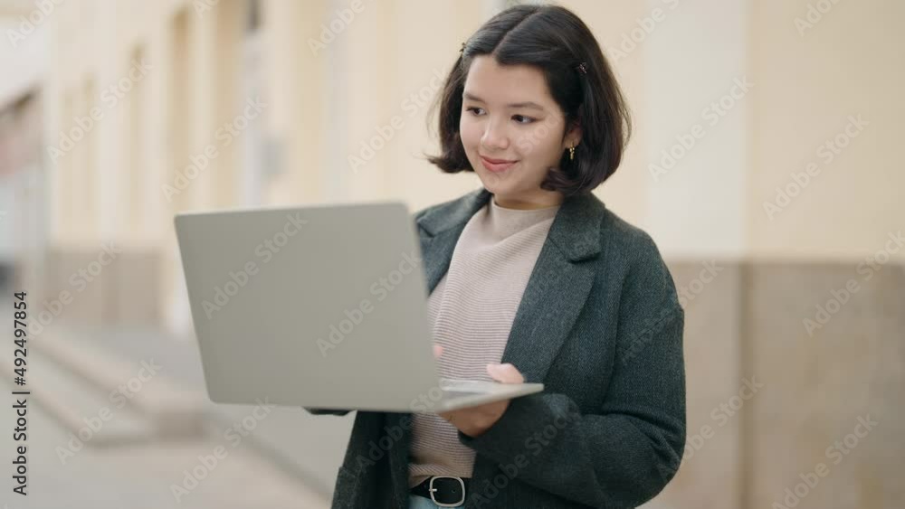 Young hispanic girl smiling confident using laptop at street Young hispanic girl smiling confident using laptop at street