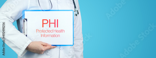PHI (Protected Health Information). Doctor with stethoscope holds blue clipboard. Text is written on document. photo