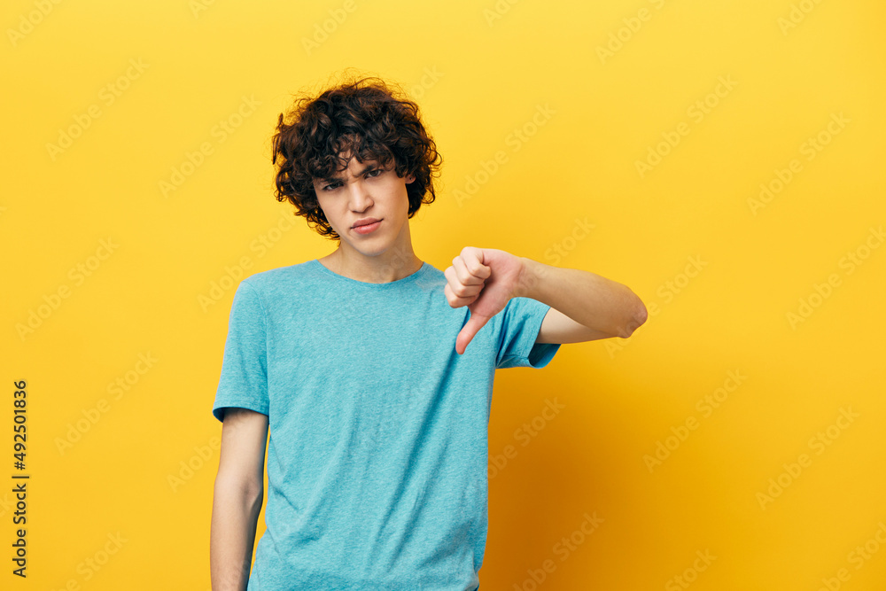thumb down emotions blue t-shirt yellow background thumb down emotions blue t-shirt yellow background