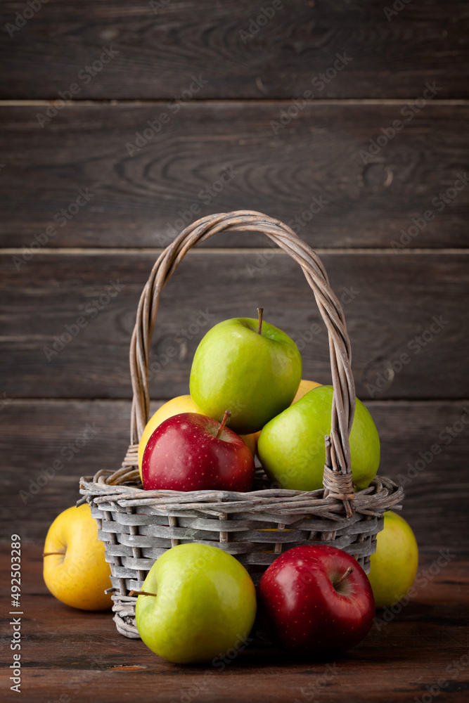 Colorful ripe apple fruits in basket