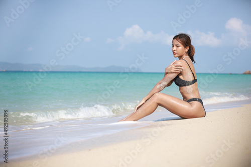 Portrait Sexy woman on the beach at island tanned woman with bikini suntan relaxing on tropical beach  summer vacation sunbathing