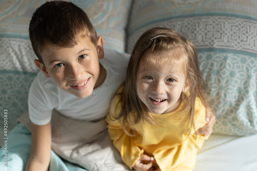 Brother with his little sister at home. Happy sister and brother together Brother with his little sister at home. Happy sister and brother together