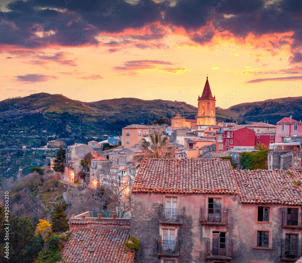 Dramatic cityscape of Novara di Sicilia town. Exciting spring sunrise in Sicily, Italy, Europe. Beautiful world of Mediterranean countries. Traveling concept background.