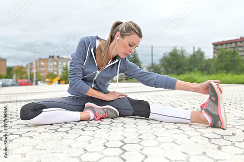 Jogger woman stretching out after exercising