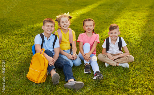 Group of preteen students on lawn in park