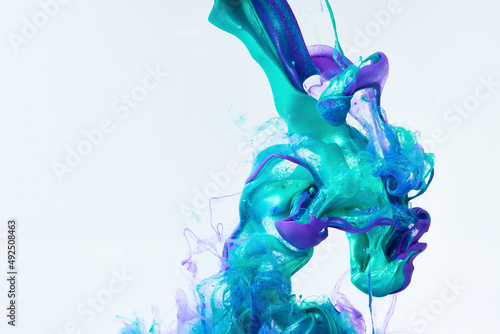 Blue and purple paint splash curves in water on white. Acrylic paint drop background. Abstract colors swirl texture