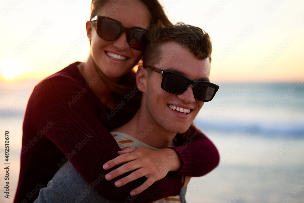 Happiness is a four letter word. Cropped portrait of an affectionate young man piggybacking his girlfriend at the beach. Happiness is a four letter word. Cropped portrait of an affectionate young man piggybacking his girlfriend at the beach.