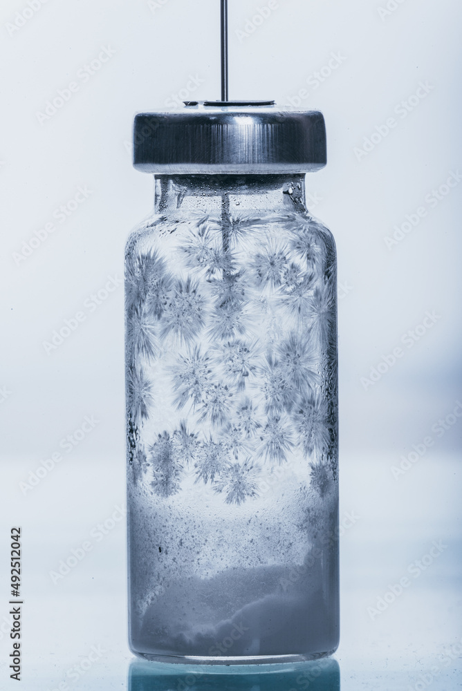 Medicine, Injection, vaccine and disposable syringe, drug concept. Sterile vial medical syringe needle. Macro close up. Glass medical ampoule vial for injection. Bottles ampule with aluminum cap. Medicine, Injection, vaccine and disposable syringe, drug concept. Sterile vial medical syringe needle. Macro close up. Glass medical ampoule vial for injection. Bottles ampule with aluminum cap.