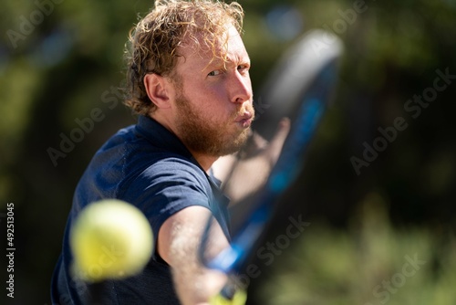 close up of Amateur reaching for a tennis ball while playing tennis in Melbourne, Australia 