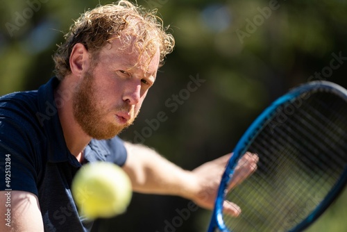 close up of Amateur reaching for a tennis ball while playing tennis in Melbourne, Australia  © William