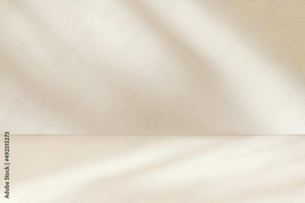 Fototapeta premium Shadow studio showcase on beige wall and floor for product presentation. Shadow sunshine and sunbeam reflection on beige empty luxury studio room