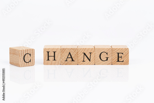 change letters on wooden cubes on white background