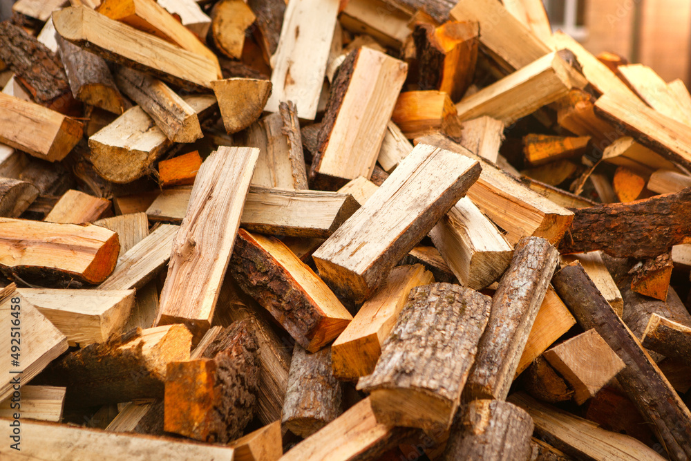 Background in the form of firewood chopped for heating the house, stacked randomly. Closeup. Background in the form of firewood chopped for heating the house, stacked randomly. Closeup.