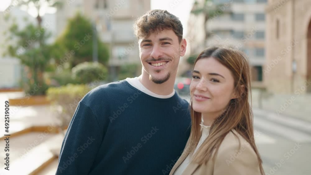 Young couple smiling confident standing together at street Young couple smiling confident standing together at street