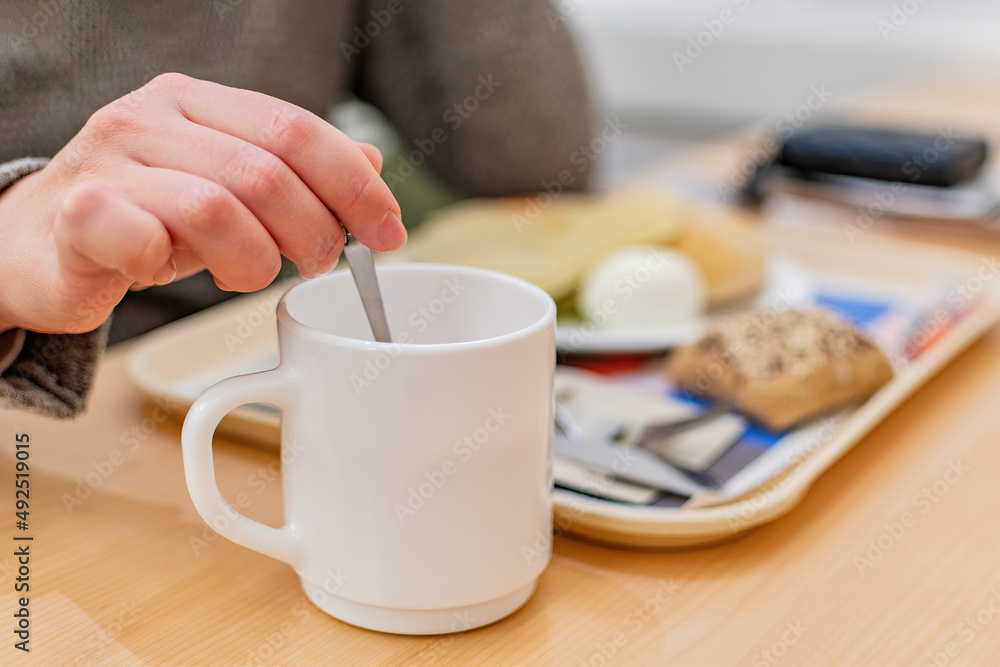 Close up of female hand with cup at breakfast. Close up of female hand with cup at breakfast.