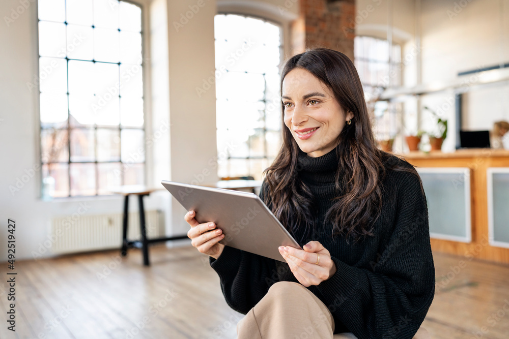 Smiling freelancer with tablet PC at home Smiling freelancer with tablet PC at home