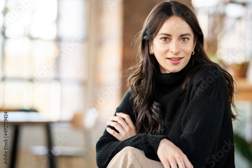 Wallpaper Mural Confident woman with arms crossed sitting at home Torontodigital.ca