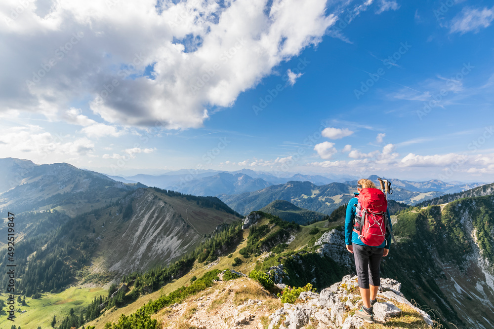 Female hiker admiring view from mountaintop Female hiker admiring view from mountaintop