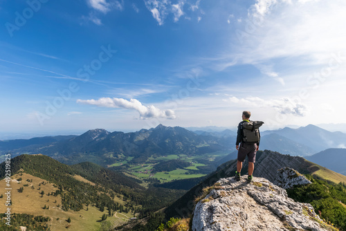 Male hiker admiring view from summit of Aiplspitz mountain