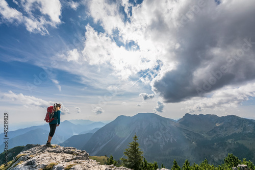 Female hiker admiring view from summit of Aiplspitz mountain photo