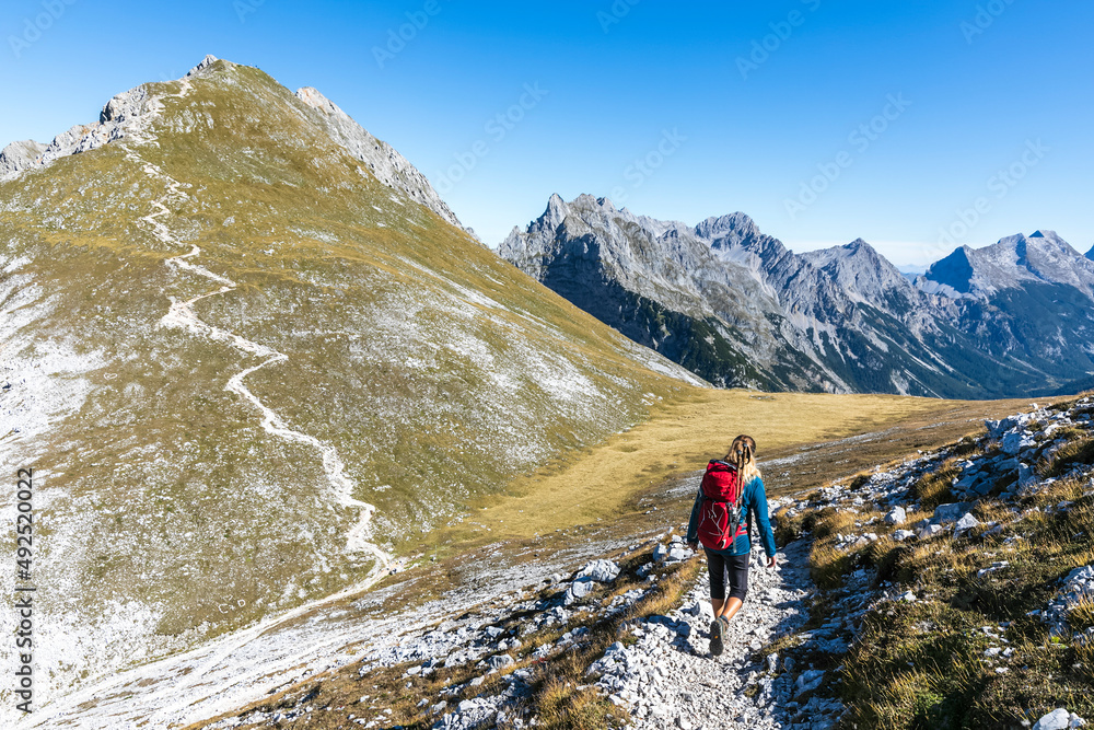 Female hiker descendingBrunnensteinspitzemountain in summer Female hiker descendingBrunnensteinspitzemountain in summer