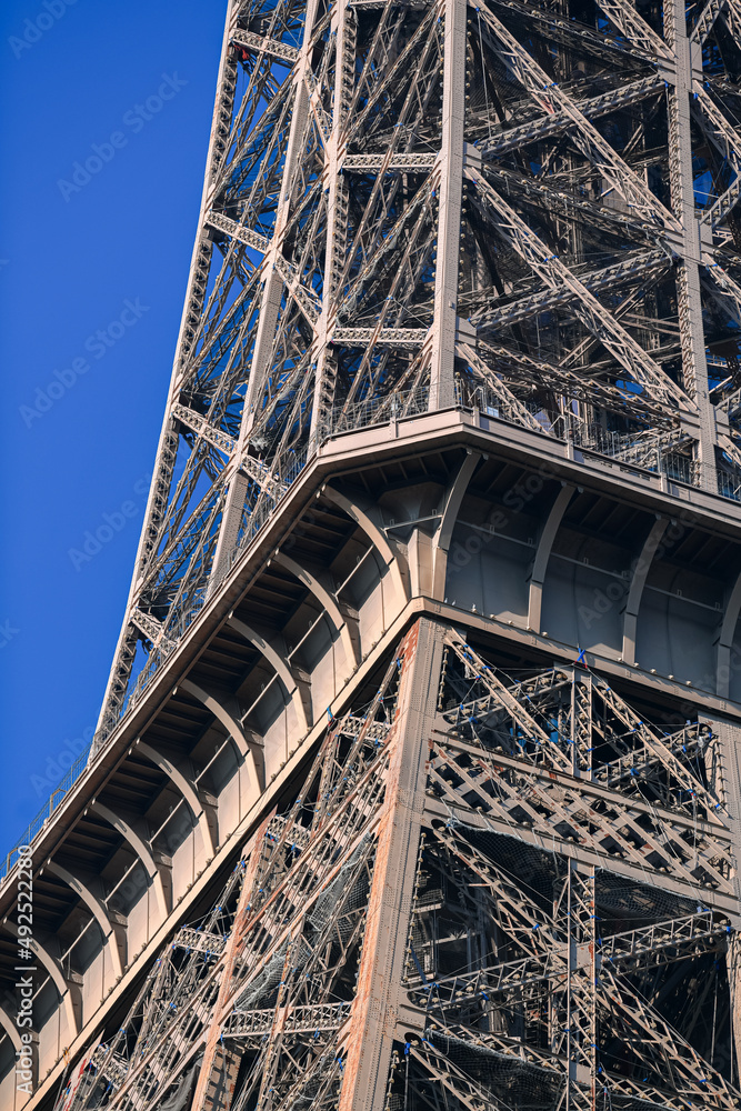 Naklejka premium Details of the structure of Eiffel Tower landmark building from Paris, France, in a sunny day