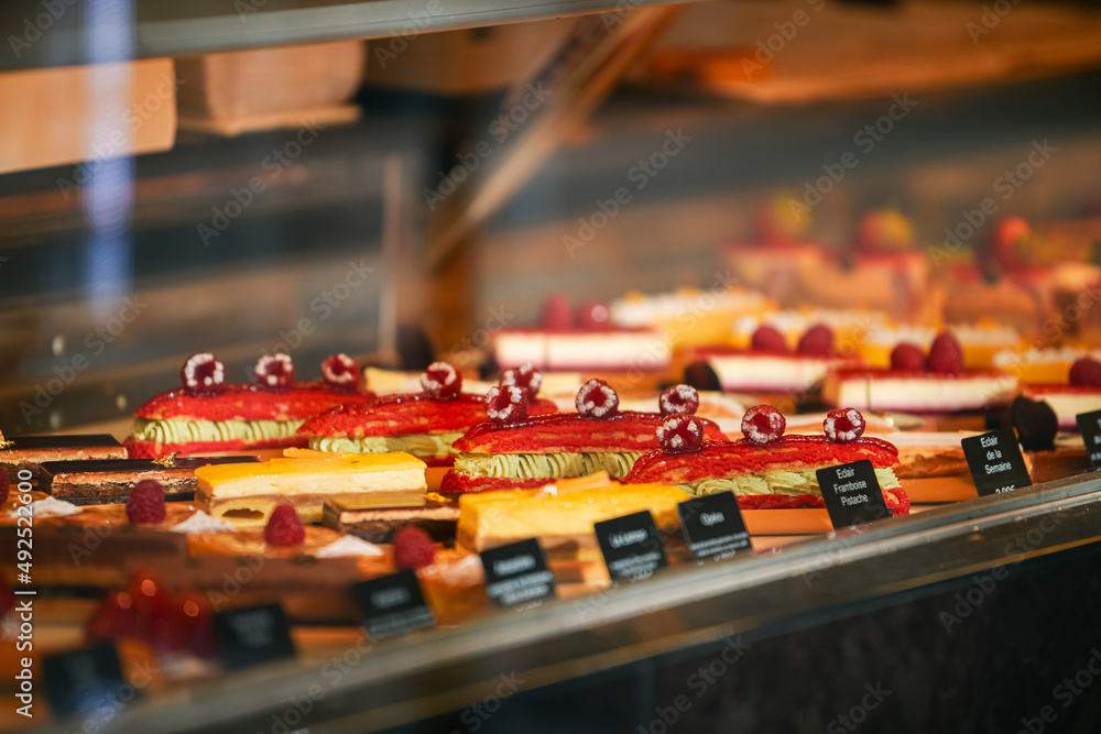 Tasty French pastry in a patisserie sweets shop from Paris. Quiches, croissants and other specific breakfast foods of France.